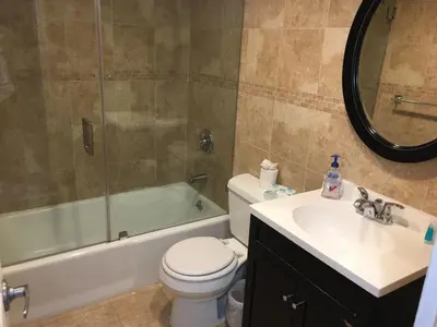 a bathroom with a sink and a toilet and a tub at Tides Apt on Hollywood Beach in Hollywood