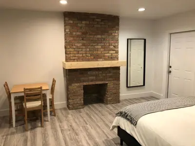 a bedroom with a fireplace and a table and a bed at Oasis Hotel in Fort Lauderdale