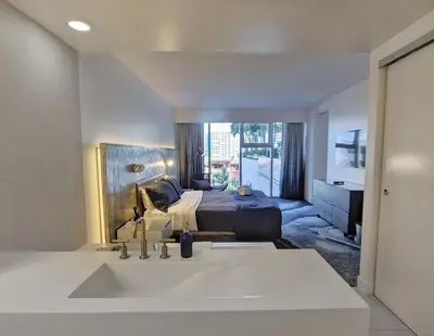 a bathroom with a sink and a bed in a room at WVR Vacation Residences 506 in Fort Lauderdale