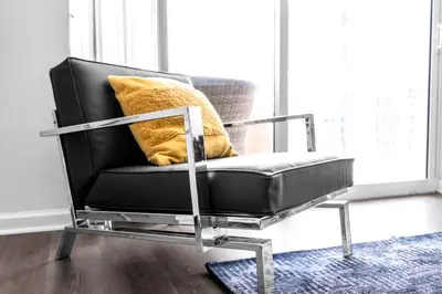 a black chair with a yellow pillow in a room at Luxurious Condo in Brickell with Free Parking in Miami