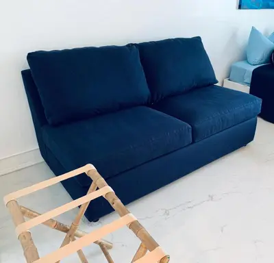 a blue couch and a wooden chair in a living room at SOBE OCEAN VIEW OCEAN DR charming studio -316 in Miami Beach