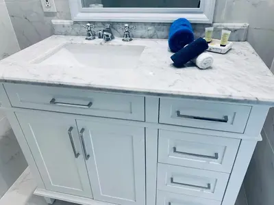 a bathroom vanity with a sink and a mirror at SOBE OCEAN VIEW OCEAN DR charming studio -316 in Miami Beach