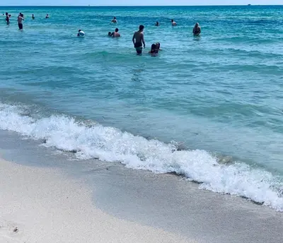 a group of people in the water at the beach at SOBE OCEAN VIEW OCEAN DR charming studio -316 in Miami Beach