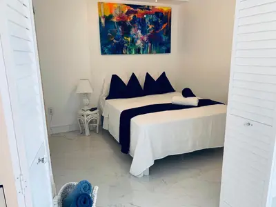 a bedroom with two beds and a painting on the wall at vacation home-ocean view SoBe 318 in Miami Beach