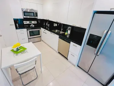 a kitchen with a white table and a refrigerator at Miami Hollywood Awesome 2 Bedroom 2 Bathroom 003-22bvic in Hollywood