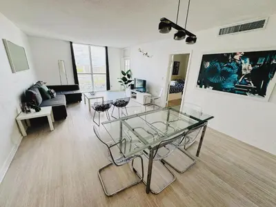 a living room with a glass table and chairs at Miami Hollywood High Rise Condo 004-22bvic in Hollywood