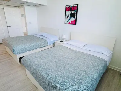 two beds in a small room with a picture on the wall at Miami Hollywood High Rise Condo 004-22bvic in Hollywood