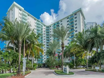 a large building with palm trees in front of it at Miami Hollywood Great 2BD Condo 009-21mar in Hollywood