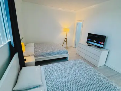 a bedroom with two beds and a flat screen tv at Miami Hollywood Great Two Bedroom Apartment with Channel View 006-22bvic in Hollywood
