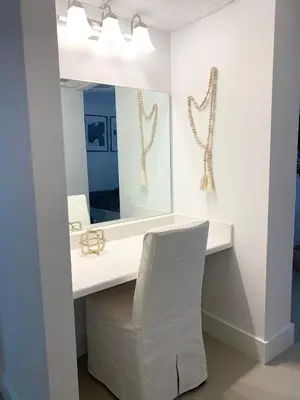 a white bathroom with a mirror and a white chair at Miami Sunny Isles ocean reserve 704 in Miami