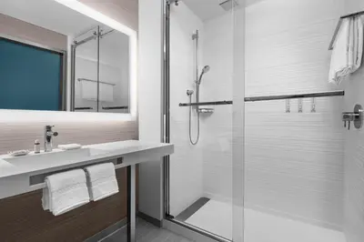 a bathroom with a glass shower and a sink at AC Hotel By Marriott Miami Brickell in Miami