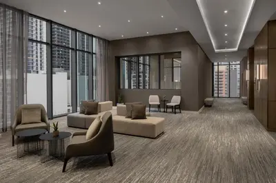 a lobby with a couch and chairs and windows at AC Hotel By Marriott Miami Brickell in Miami