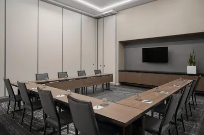 a conference room with tables and chairs and a screen at AC Hotel By Marriott Miami Brickell in Miami