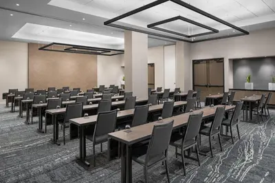 a conference room with tables and chairs and a screen at AC Hotel By Marriott Miami Brickell in Miami