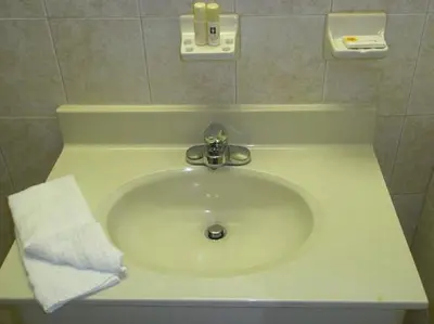 a white sink in a bathroom with a towel at Miami Princess Hotel in Miami