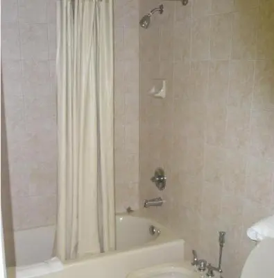 a bathroom with a shower and a tub and a toilet at Miami Princess Hotel in Miami