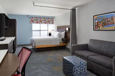 a hotel room with a bed and a couch at Home2 Suites by Hilton Miramar Ft. Lauderdale in Miramar