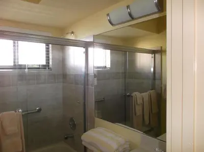 a bathroom with a shower and a glass shower backdoor at Hollywood Sands Resort in Hollywood