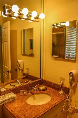 a bathroom with a sink and a large mirror at Hollywood Sands Resort in Hollywood