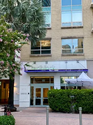 a building with a tree in front of it at Miami Midtown Luxury Apartment in Miami