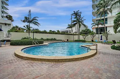 a swimming pool in a courtyard in a building at Luxury Beachfront Apartments 4001 S Ocean Dr in Hollywood