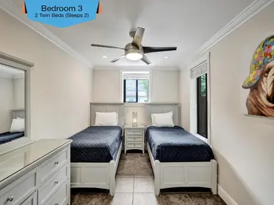 a bedroom with two beds and a ceiling fan at Vidal Manor in Fort Lauderdale