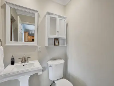 a white bathroom with a sink and a toilet at Vidal Manor in Fort Lauderdale