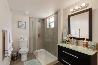 a bathroom with a shower and a toilet and a sink at 2 Bedroom 2 Bath With Patio On 11th Collins ave in Miami Beach
