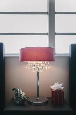 a lamp sitting on a table next to a box at 2 Bedroom 2 Bath With Patio On 11th Collins ave in Miami Beach