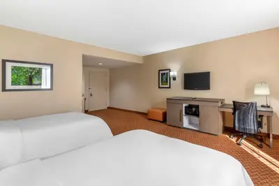 a hotel room with two beds and a desk at Best Western Plus Kendall Hotel & Suites in Kendall