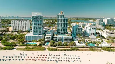 an aerial view of a city with a beach and buildings at Monte Carlo Miami Beach in Miami Beach
