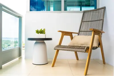 a chair and a table in a room with a window at Monte Carlo Miami Beach in Miami Beach