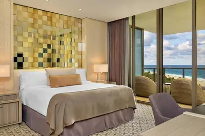 a bedroom with a bed and a view of the ocean at The St. Regis Bal Harbour Resort in Miami Beach