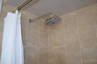 a shower with a shower head and a shower curtain at La Terrace Oceanfront in Hollywood