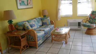 a living room with a couch and a table at Atlantic Sands Beach Suites in Hollywood