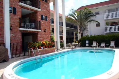a large swimming pool in front of a building at Large Lush Oasis Paradise by FLL Beach and Galleria - 2bd 2ba in Fort Lauderdale