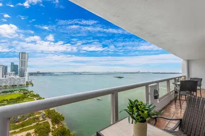 a balcony with a view of the water at StayCozy Apartments at The Grand in Miami
