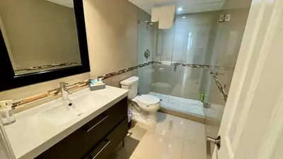 a bathroom with a sink and a toilet and a shower at Sunny Isles Condo Resort in Miami Beach
