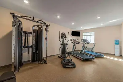 a gym with three tread machines in a room at WoodSpring Suites Miramar in Miramar