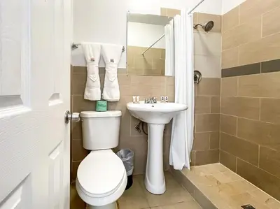 a bathroom with a toilet and a sink at The Flamingo in Hollywood