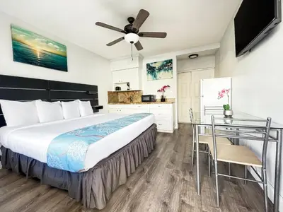 a bedroom with a large bed and a desk at The Flamingo in Hollywood