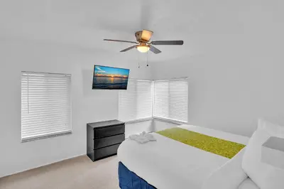 a bedroom with a bed and a ceiling fan at The Swan in Hollywood
