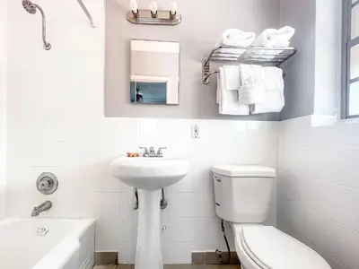 a white bathroom with a sink and a toilet at The Blue Wave in Hollywood