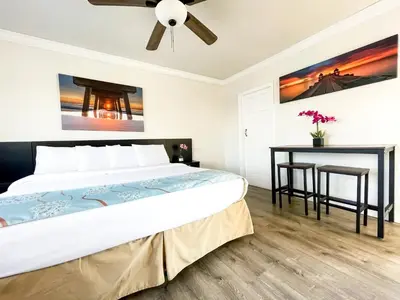 a bedroom with a bed and a table at The Seagull in Hollywood