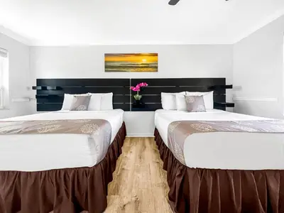 two beds sitting next to each other in a room at Hollywood Beach Seaside in Hollywood