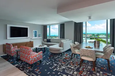 a living room with a couch and a table and chairs at Le Meridien Dania Beach at Fort Lauderdale Airport in Dania Beach