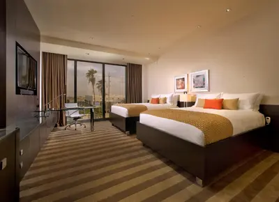 a hotel room with two beds and a television at EB Hotel Miami Airport in Miami