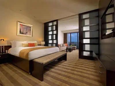 a bedroom with a bed and a bench in a room at EB Hotel Miami Airport in Miami