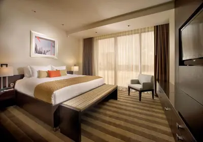 a hotel room with a bed and a chair at EB Hotel Miami Airport in Miami