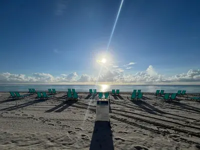 a group of chairs on a beach with the sun at Miami Hollywood Great 2 Bedroom 2 Bathroom with Intercostal View 001-22bvic in Hollywood